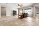 Bright living room with travertine tile flooring, large windows, and plenty of space for entertaining at 11958 W Villa Chula Ln, Sun City, AZ 85373