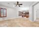 Open floorplan displaying tile floors, wood shutters, and view into the kitchen with wood cabinets and appliances at 11958 W Villa Chula Ln, Sun City, AZ 85373
