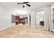 Open living space with view into kitchen with stainless appliances, island, and access to patio at 11958 W Villa Chula Ln, Sun City, AZ 85373