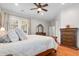 A main bedroom featuring wood floors, a ceiling fan, and access to balcony at 11958 W Villa Chula Ln, Sun City, AZ 85373