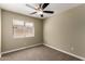 Cozy bedroom with a window dressed with blinds and plush carpeting at 13439 W Desert Ln, Surprise, AZ 85374