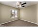 Cozy bedroom featuring neutral paint and a window with a view at 13439 W Desert Ln, Surprise, AZ 85374