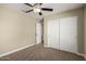 Bedroom featuring neutral walls, carpet, ceiling fan, and a closet with sliding doors at 13439 W Desert Ln, Surprise, AZ 85374
