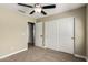Bedroom featuring neutral walls, carpet, ceiling fan, and a closet with sliding doors at 13439 W Desert Ln, Surprise, AZ 85374