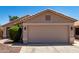 Attractive home featuring a spacious two-car garage and manicured front yard at 13439 W Desert Ln, Surprise, AZ 85374
