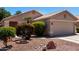 Front yard with mature landscaping at 13439 W Desert Ln, Surprise, AZ 85374