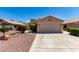 Charming single-story home with well-maintained landscaping and a two-car garage at 13439 W Desert Ln, Surprise, AZ 85374