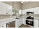 Modern kitchen featuring stainless steel appliances, white cabinetry and a window at 13439 W Desert Ln, Surprise, AZ 85374