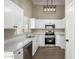 Charming kitchen featuring stainless steel appliances and white cabinetry at 13439 W Desert Ln, Surprise, AZ 85374