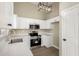 Modern kitchen with stainless steel appliances and white cabinets at 13439 W Desert Ln, Surprise, AZ 85374