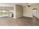 Spacious living area featuring sleek wood floors, recessed lighting and easy access to kitchen and bathrooms at 13439 W Desert Ln, Surprise, AZ 85374