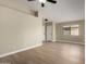 Bright and airy living room with wood floors, tall ceilings, and lots of space at 13439 W Desert Ln, Surprise, AZ 85374