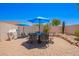 Relaxing backyard patio with outdoor dining set and grill under bright blue skies at 13824 N 148Th Ln, Surprise, AZ 85379