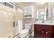 Bathroom features a glass shower, cherry vanity, and ample storage space at 13824 N 148Th Ln, Surprise, AZ 85379