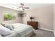 Cozy bedroom with plush carpet, ceiling fan, and a view to a garden at 13824 N 148Th Ln, Surprise, AZ 85379