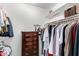 Walk-in closet featuring shelving and hanging racks with dresser at 13824 N 148Th Ln, Surprise, AZ 85379