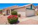 Single Gathering house featuring a two-car garage, front entrance, and manicured landscaping at 13824 N 148Th Ln, Surprise, AZ 85379