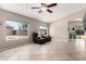 Bright living room featuring large windows, tile flooring, and open floor plan at 13824 N 148Th Ln, Surprise, AZ 85379