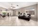 Bright living room with tile floors and dark brown seating area at 13824 N 148Th Ln, Surprise, AZ 85379