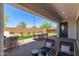 Outdoor back patio area with seating, dining table, and a built-in grill at 14116 W Honeysuckle Dr, Surprise, AZ 85387