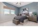 Well-lit bedroom with modern decor, comfortable bed, and stylish window coverings at 14116 W Honeysuckle Dr, Surprise, AZ 85387