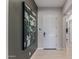 Modern entryway featuring sleek tile floors and stylish decor at 14116 W Honeysuckle Dr, Surprise, AZ 85387