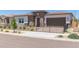 Inviting single-story home featuring desert landscaping, a sleek black fence, and a charming facade at 14116 W Honeysuckle Dr, Surprise, AZ 85387