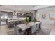 Modern kitchen with gray cabinets, stainless steel appliances, and a breakfast bar at 14116 W Honeysuckle Dr, Surprise, AZ 85387