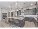 Spacious island kitchen with counter seating and views of the living and dining areas at 14116 W Honeysuckle Dr, Surprise, AZ 85387