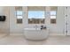 Bright bathroom showcasing a freestanding tub and a window with natural light at 14116 W Honeysuckle Dr, Surprise, AZ 85387