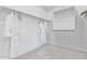 Clean and organized walk-in closet with shelving and hanging rods for ample storage at 14116 W Honeysuckle Dr, Surprise, AZ 85387
