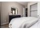 Cozy bedroom features plush bedding, minimalist decor, and a spacious closet for ample storage at 14124 W Honeysuckle Dr, Surprise, AZ 85387