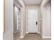 Bright entryway featuring neutral walls, clean lines, and a modern white front door at 14124 W Honeysuckle Dr, Surprise, AZ 85387