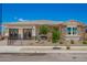 Attractive single-story home featuring stone accents, desert landscaping, and a charming gated front yard at 14124 W Honeysuckle Dr, Surprise, AZ 85387