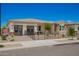 Charming single-story home showcasing desert landscaping and a welcoming gated front yard and stone accents at 14124 W Honeysuckle Dr, Surprise, AZ 85387