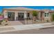 Charming single-story home showcasing desert landscaping and a welcoming gated front yard with stone accents at 14124 W Honeysuckle Dr, Surprise, AZ 85387