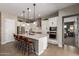 Modern kitchen with white cabinets, stainless steel appliances, and large island with seating at 14124 W Honeysuckle Dr, Surprise, AZ 85387
