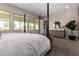 Bright main bedroom featuring large windows and a stylish ensuite with a calming neutral palette at 14124 W Honeysuckle Dr, Surprise, AZ 85387
