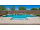 Beautiful swimming pool with water feature and Baja shelf framed by stone pavers and desert landscaping at 14124 W Honeysuckle Dr, Surprise, AZ 85387