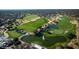 Aerial view of a well-maintained golf course with lush green fairways, serene water features, and mature trees at 15159 W Gray Fox Trl, Surprise, AZ 85387