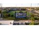 Full view of a manicured baseball field and stadium seating with surrounding community and clear blue skies at 15159 W Gray Fox Trl, Surprise, AZ 85387