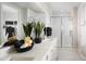 Bathroom showcasing double sinks, quartz countertops, and a glass-enclosed shower, blending functionality with elegant design at 15159 W Gray Fox Trl, Surprise, AZ 85387