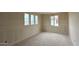 Spacious bedroom with three windows, offering natural light, and modern interior features at 15159 W Gray Fox Trl, Surprise, AZ 85387