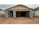 New construction home featuring a large garage and a covered entryway in a residential neighborhood at 15159 W Gray Fox Trl, Surprise, AZ 85387