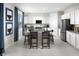 Modern kitchen with stainless steel appliances, granite countertops, a large island, and white cabinets at 15159 W Gray Fox Trl, Surprise, AZ 85387