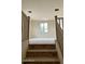 Upstairs living room featuring a large window and wood railing staircase at 15159 W Gray Fox Trl, Surprise, AZ 85387