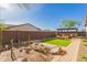 Expansive backyard offers drought-tolerant desert landscaping, seating area, pergola-covered outdoor kitchen, perfect for entertaining at 1526 E Hazel Dr, Phoenix, AZ 85042