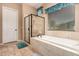 Bright bathroom features a soaking tub with a glass shower and travertine tile at 1526 E Hazel Dr, Phoenix, AZ 85042
