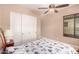 Bedroom with neutral paint, ceiling fan, and closet with sliding doors at 1526 E Hazel Dr, Phoenix, AZ 85042