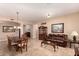 Well-lit dining room with travertine flooring leading to a cozy living area at 1526 E Hazel Dr, Phoenix, AZ 85042